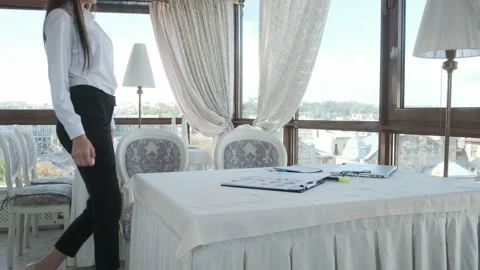 Young girl comes to the table, sits down and opens the laptop Stock Footage 130915530