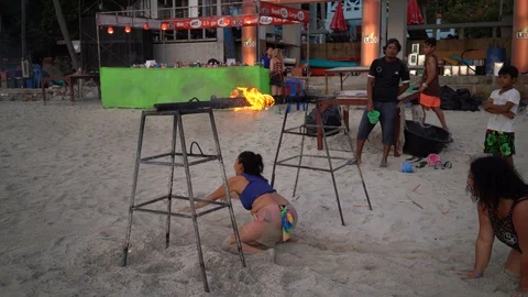 A young girl crawls over a burning fire 스톡 동영상 106969237