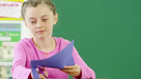 Young girl cutting construction paper Video stock 80131270