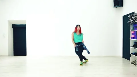 Young girl dancing energetically on a white background. Stock Footage 150899211