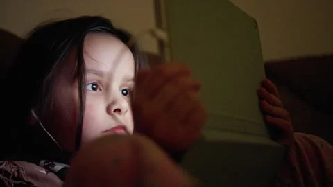 A Young Girl Deeply Engaged in a TabletBased Activity While Enjoying Her Time at Stock-Footage 304800246