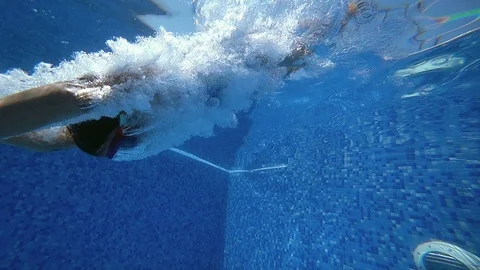 Young girl dive in blue swimming pool. Stock Footage