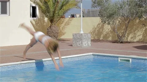 Young girl dive into pool Stock Footage 42552433