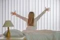 The young girl do exercise near the bed Photo