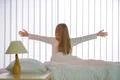 The young girl do exercise near the bed Photo