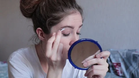 Young girl do makeup looking in mirror Stock Footage 127744268