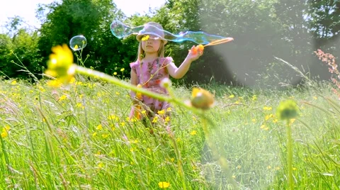 Young girl doing bubbles in the sun 4K Stock Footage 50901768