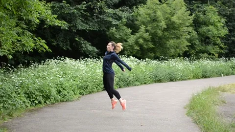 Young girl doing burpee exercise at the stadium Stock Footage 135677102