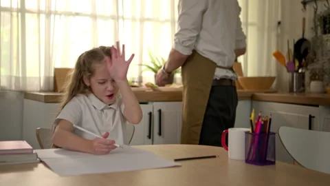 Young girl doing homework alone at the table Stock-Footage 340939207