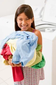 Young girl doing laundry Stock Photos