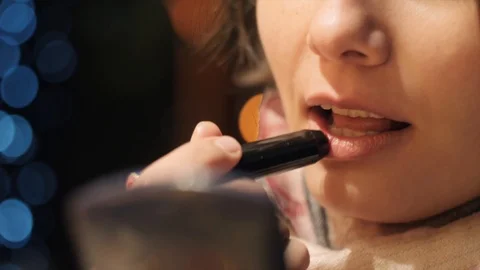 Young girl doing lips make-up Stock Footage 118124758