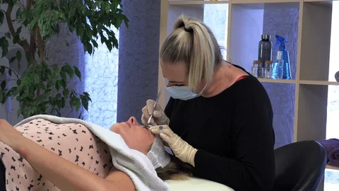 Young girl doing microblading procedure Stock Footage 114108752