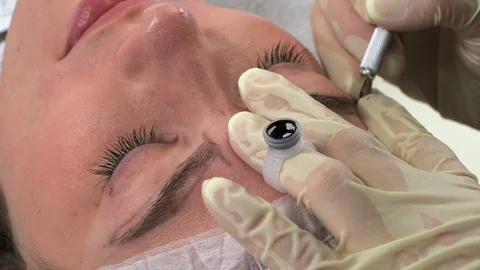 Young girl doing microblading procedure Видео 114199022