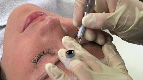 Young girl doing microblading procedure Stock Footage 114351158