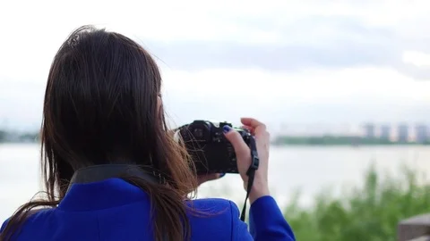 Young girl doing a video on the camera. To pose for the camera. Fun outdoors Video stock 76490634