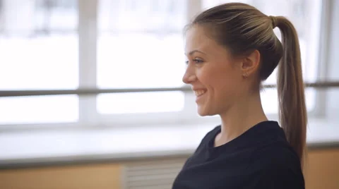 Young girl doing a work-out in the dance hall. smiles. Stock Footage 58163442