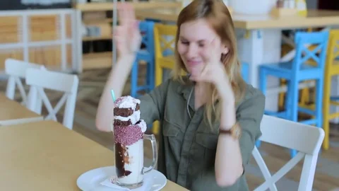 Young girl is drinking cocktail in cafe Stock Footage