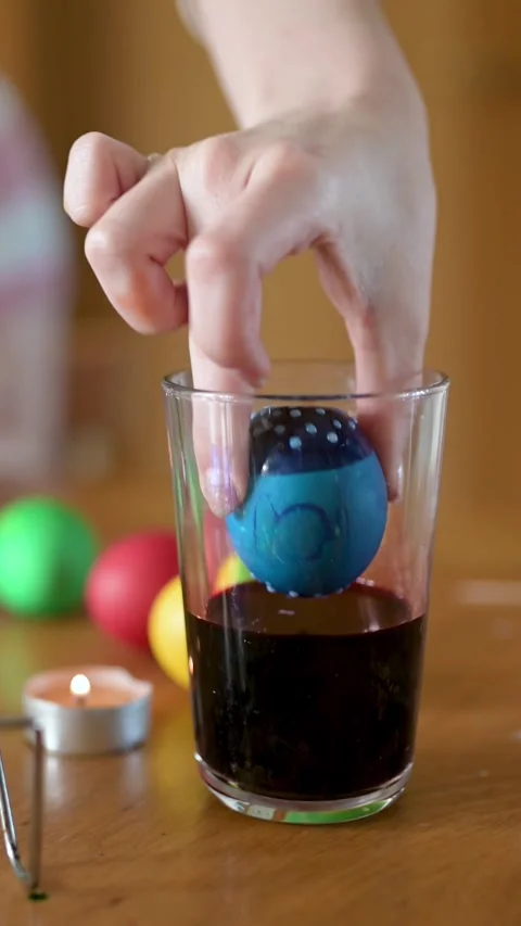 Young girl dyeing Easter eggs at home. Slow motion vertical close-up footage. 스톡 동영상 304086835