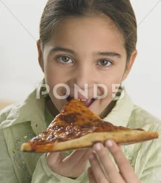 Young girl eating pizza Stock Photos