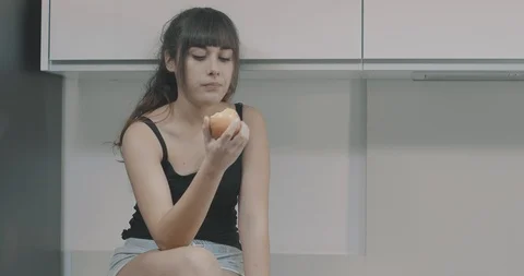 Young girl eats an apple Video stock 101057234