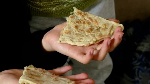 A young girl eats bread in her hand, a young girl shares the bread on her hands, Stock Footage 104618828