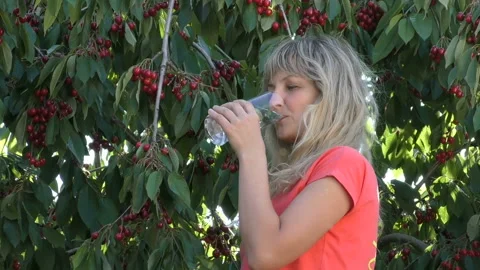 Young girl eats cherry Stock Footage 90525922