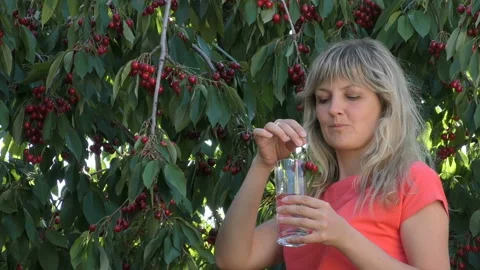 Young girl eats cherry Stock Footage 90526318