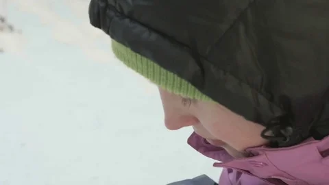 Young girl eats chips in the winter forest Stock Footage 73895730