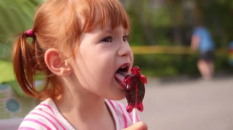 A young girl eats corn off of the cob Stock Footage 66464751