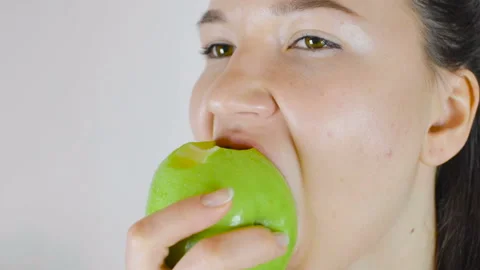 A young girl eats a green apple. Healthy food, vegetarianism Stock Footage 105396387
