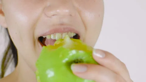 A young girl eats a green apple. Healthy food, vegetarianism Stock Footage 105396545