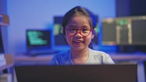 Young girl engaged in coding activity at night with computer screens displa.. Stock Footage 319928941
