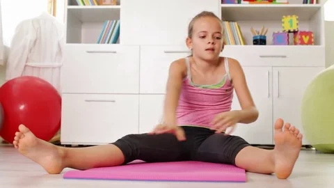 Little Girl Doing Stretching Home Stock Footage Video (100% Royalty-free)  1073641118