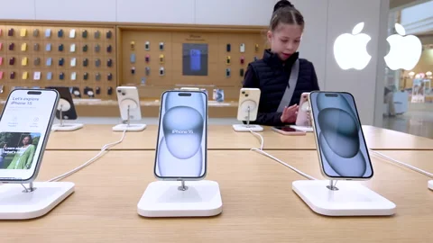 Young Girl Exploring New iPhone Models at an Apple Store Stock Footage 327018663