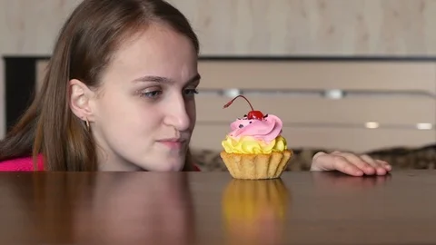 A young girl found a cake but cannot eat it Stock Footage 126283665