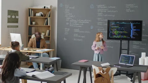 Young Girl Giving Presentation on Programming in front of Class Stock Footage 244698210