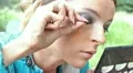 The young girl glues eyelashes on the street HD Footage