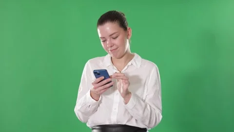 Young girl on green screen background is typing text message Stock Footage 341377166