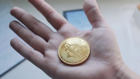 Young Girl Hand With a Bitcoin In her Palm Stock Footage