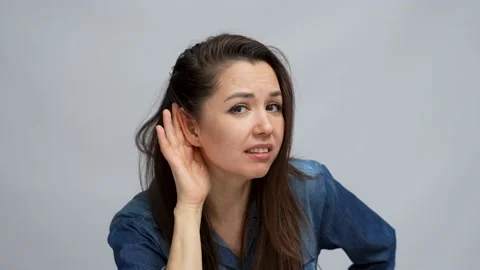 Young girl with hand on ear. What did you say Stock Footage 238989341