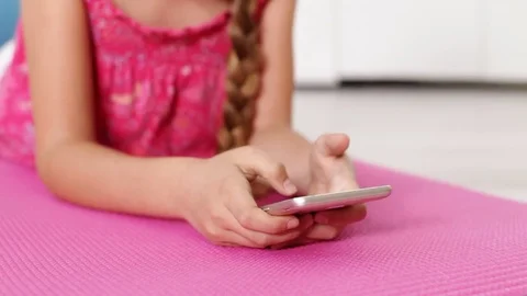 Young girl hands using smartphone lying on the floor Video stock 80144893