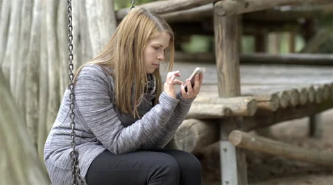 Young girl having fun playing game on cell phone 4k Stock Footage 68299561