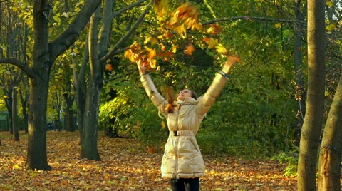 Young Girl Having Fun Throwing Yellow Leaves. Stock Footage 56856093