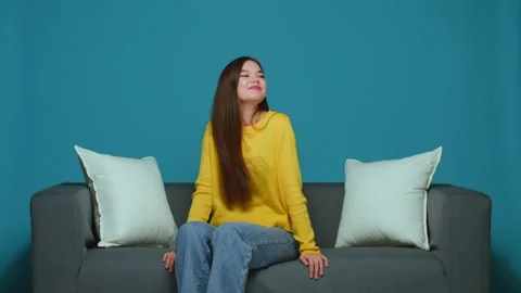 Young girl having fun watching comedy show, laughing to humor, joke of funny TV Stock Footage 213937212