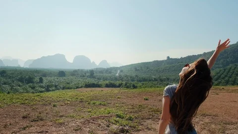 Young girl is having fun while dancing and jumping with their hands raised Stock Footage 129863729