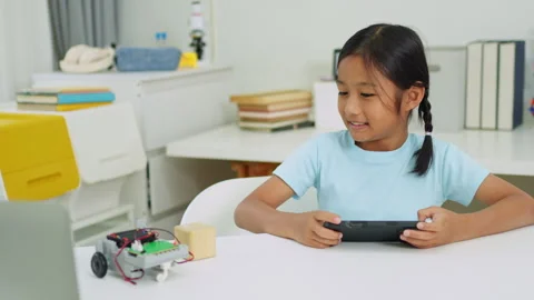 Young girl having fun working on a robot design Stock Footage 331853577