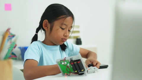 Young girl having fun working on a robot design Stock Footage 331855756