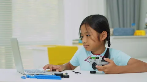 Young girl having fun working on a robot design Stock Footage 331855770