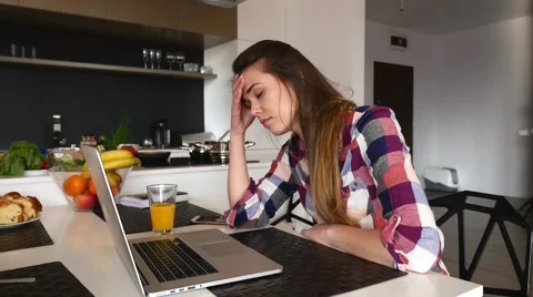 Young girl having problems with homework. She is sad. She is using her laptop Stock Footage 61859354