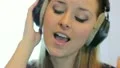 The young girl with headphones (earpiecess) HD Footage